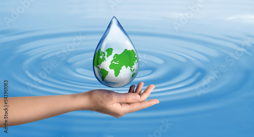 Woman holding icon of Earth in drop on blue background, closeup. Water save concept
