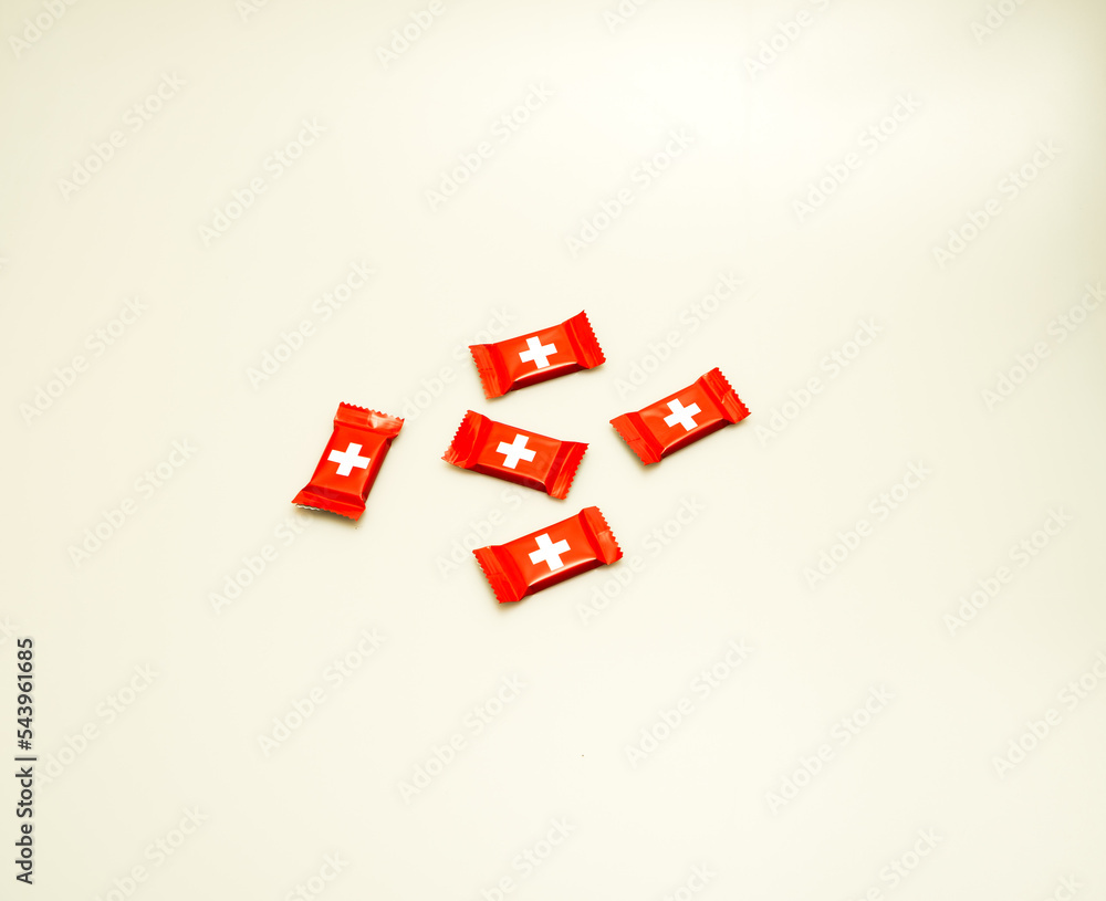 A top-down studio shot of Swiss chocolate pieces isolated against a white background. A top-down studio shot of Swiss chocolate pieces isolated against a white background.