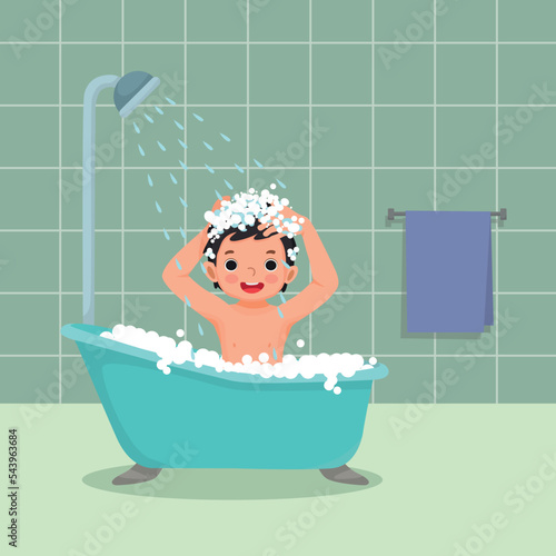 Cute little boy taking a bath in the bathtub