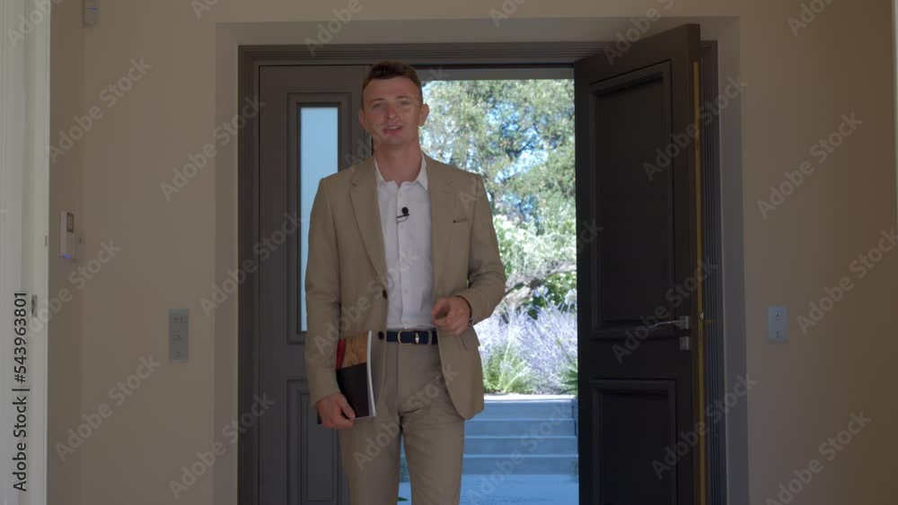 Real estate agent giving an enterence for the property that he's selling. Real estate agent giving an enterence for the property that he's selling.