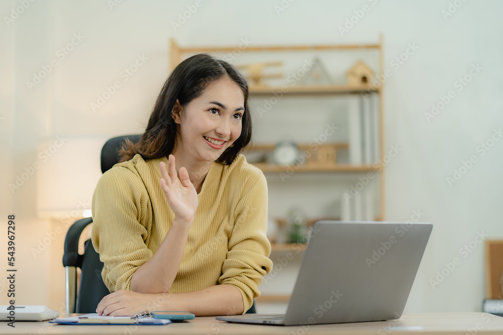 Asian female accountant working using laptop to analyze technical price charts and indicators with a team of business, accounting or savings online work at home ideas. Asian female accountant working using laptop to analyze technical price charts and indicators with a team of business, accounting or savings online work at home ideas.