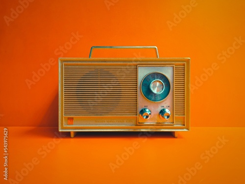 old transistor radio isolated orange wall background