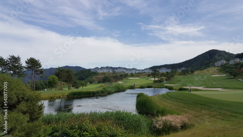 Panorama view of golf course in Korea. Beautiful scenery with blue sky. © TaeHeon