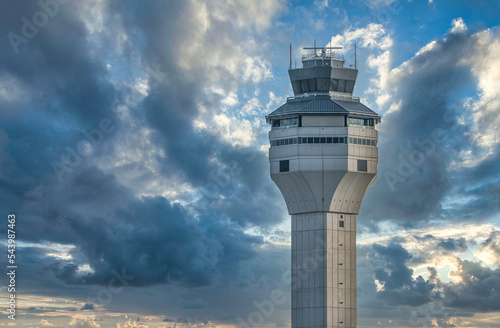 Airtraffic control tower against dramatic cloudy sunset sky photo