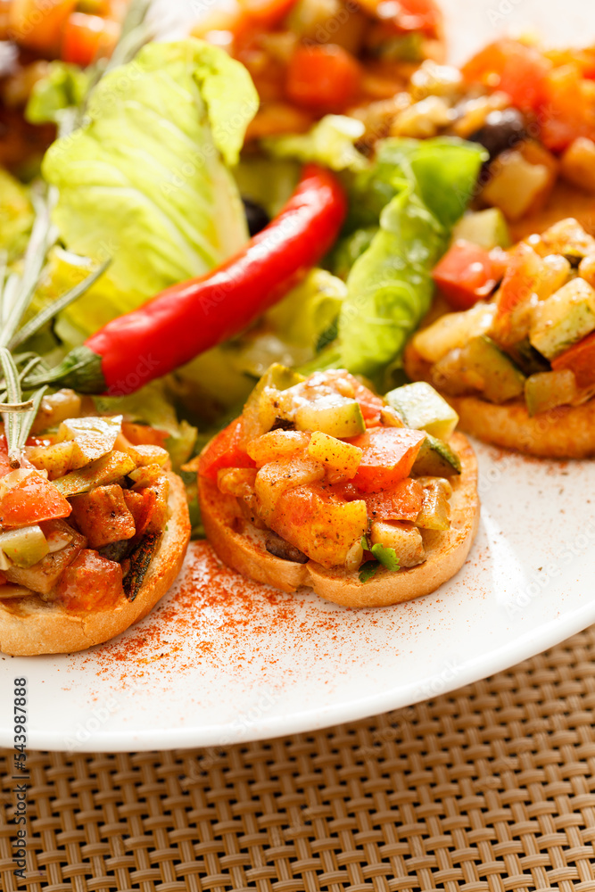 bruschetta with vegetables on white plate bruschetta with vegetables on white plate