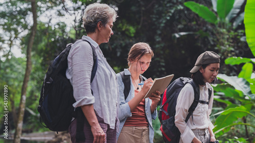 happy women enjoying nature travel.female traveler carrying a backpack.Hiking tourists use maps to travel.woman  look at nature in the mountains.