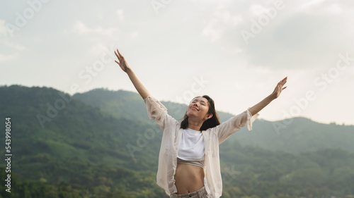 woman looking at the view enjoy the mountains.happy women enjoying nature travel.Female tourists see nature on the top of the mountain.