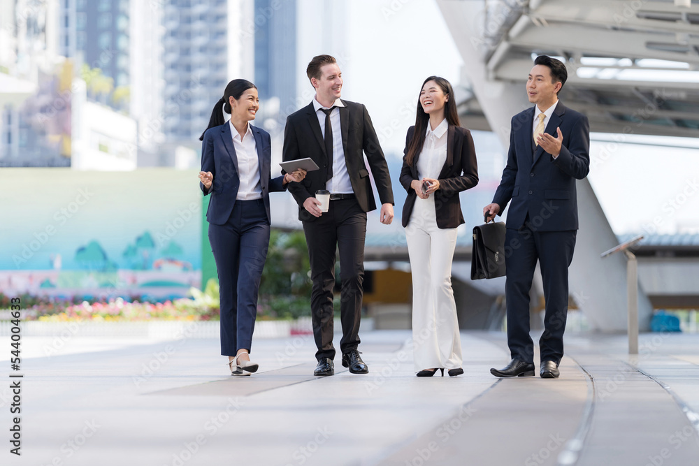 Business people walking and talk to each other in front of modern office Business people walking and talk to each other in front of modern office