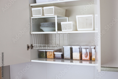 House decor ideas. Storage in the kitchen. Home organization. White shelf and modern interior. photo