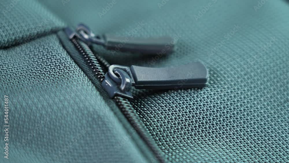 Lock zipper of a colored tourist backpack close-up. Security concept. Macro. Rotation Lock zipper of a colored tourist backpack close-up. Security concept. Macro. Rotation