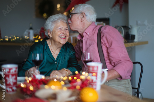 Happy senior couple celebrating Christmas Eve together.