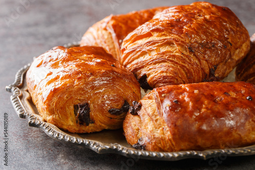 Fotografia Homemade Chocolate Croissants Pain au Chocolat closeup in the plate on the table
