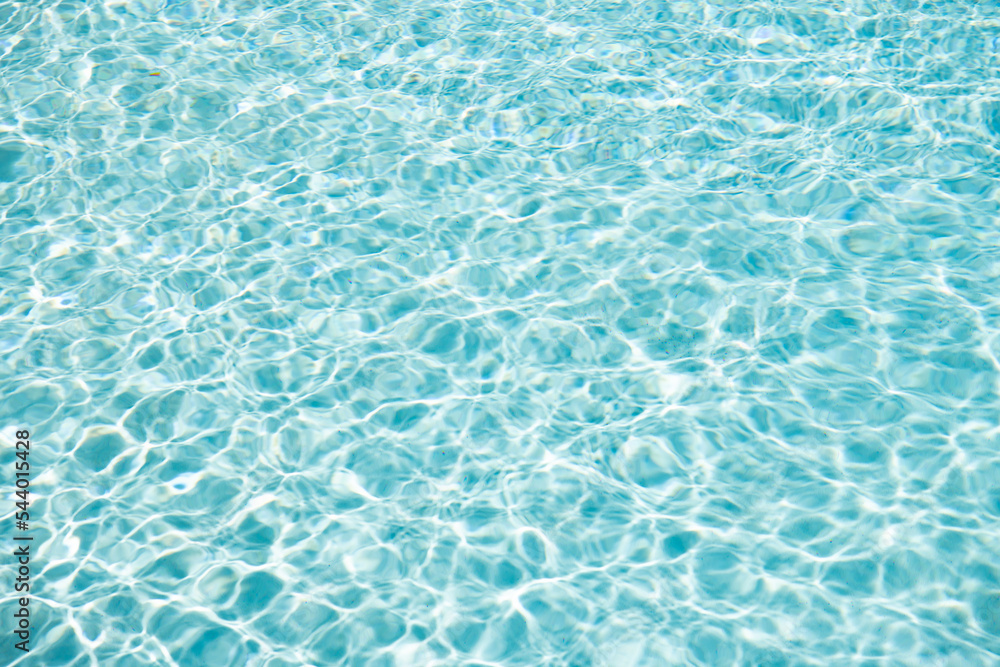 summer paradise. blue swimming pool water background with ripples