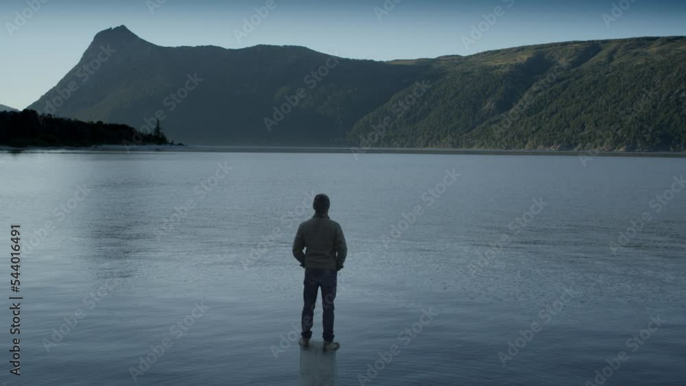Unrecognizable Man Looking Out over Lake, Rear View, Gentle Pan. Unrecognizable Man Looking Out over Lake, Rear View, Gentle Pan.
