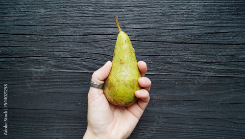 hand holding pear