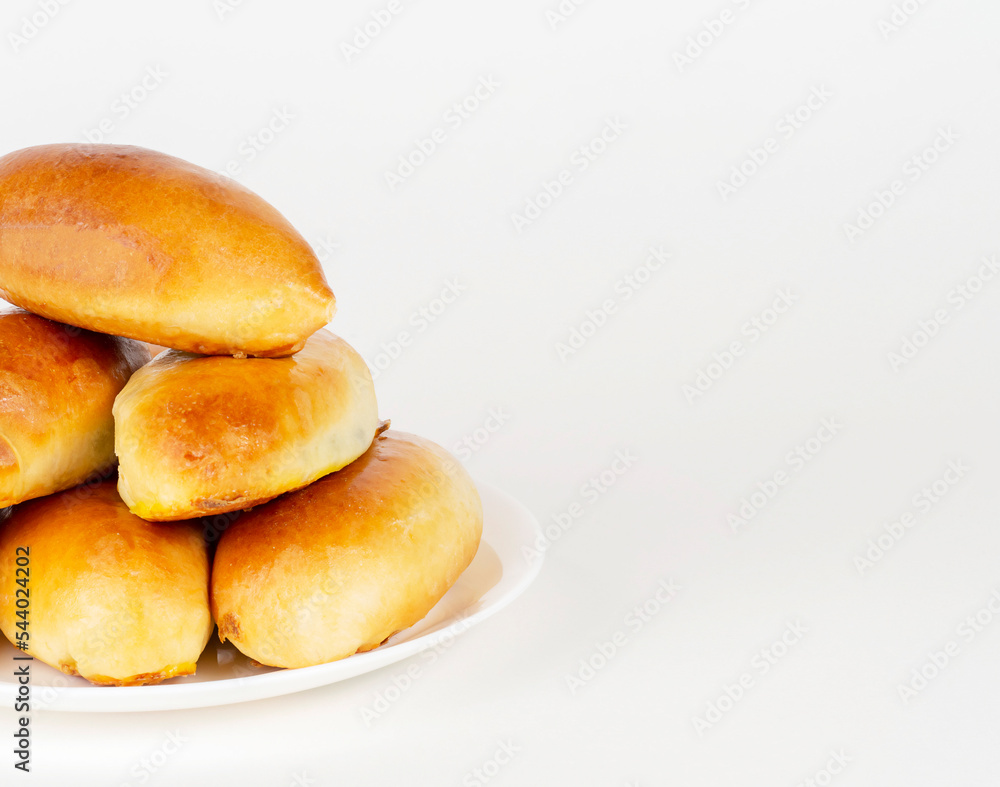 Pies on a white plate on a white background.