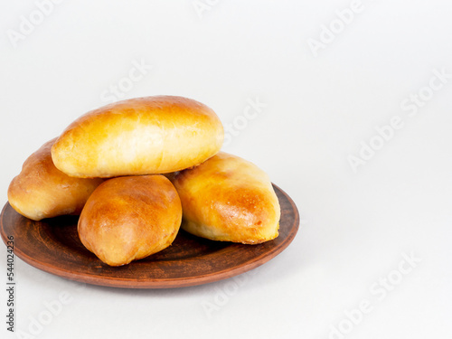 Pies on a dark plate on a white background.
