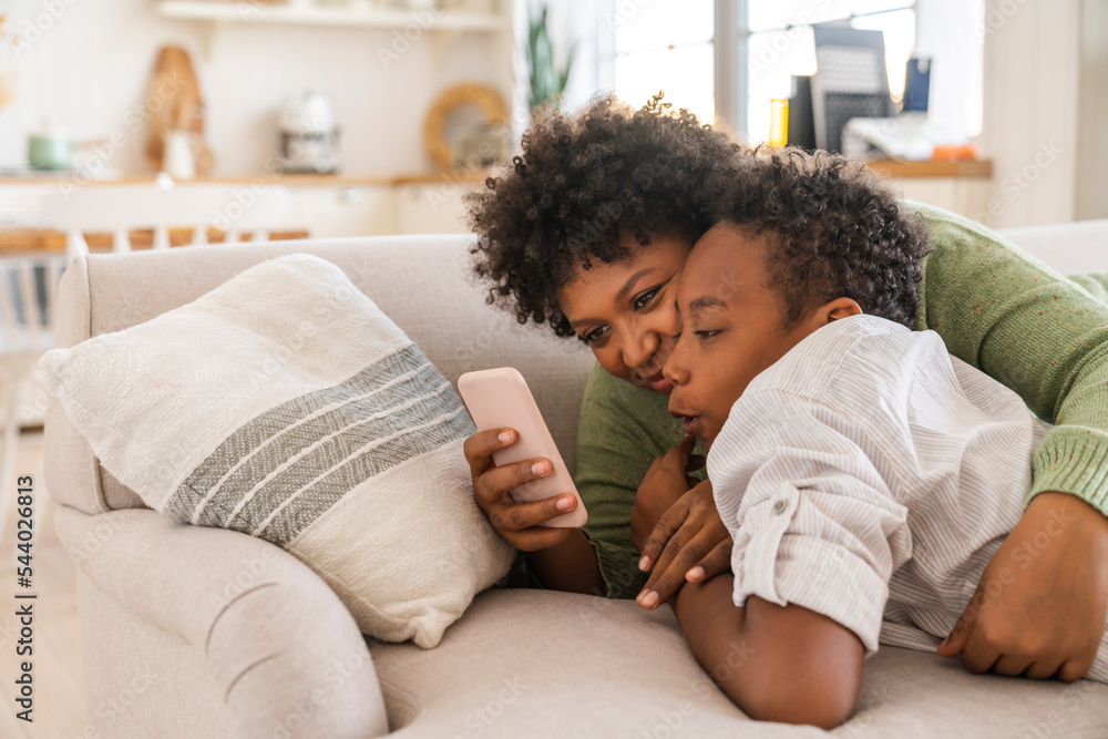 Happy mother with son using smart phone at home Happy mother with son using smart phone at home