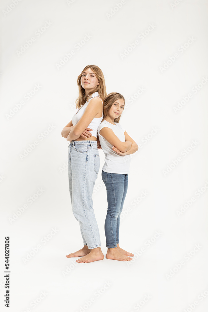 Confident girls with arms crossed in studio Confident girls with arms crossed in studio