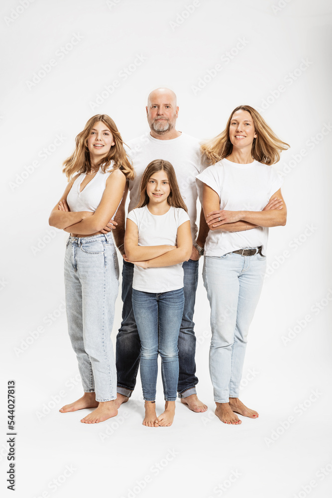 Smiling woman and daughters with arms crossed by man in studio Smiling woman and daughters with arms crossed by man in studio