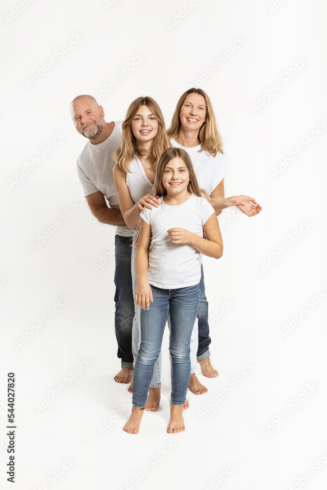 Smiling daughters and parents against white background Smiling daughters and parents against white background
