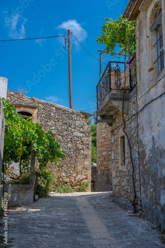 Empty alley with buildings under blue sky