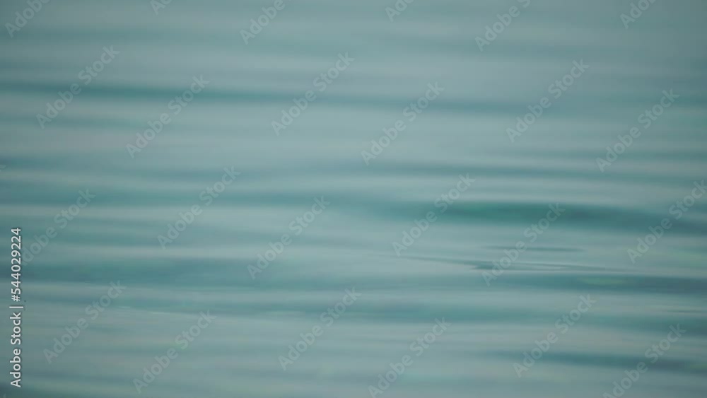 Abstract sea summer ocean sunset nature background. Small waves on water surface in motion blur with golden bokeh lights from sun. Holiday, vacation and recreational concept. Slow motion Abstract sea summer ocean sunset nature background. Small waves on water surface in motion blur with golden bokeh lights from sun. Holiday, vacation and recreational concept. Slow motion