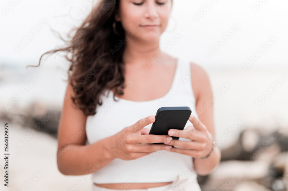 Young woman using smart phone at beach Young woman using smart phone at beach