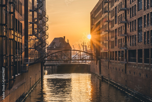Germany, Hamburg, Canal in Speicherstadt district at sunset photo