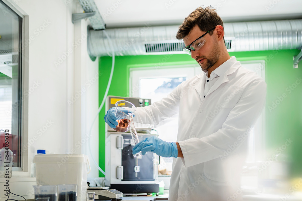 Scientist practicing thermolysis experiment in laboratory Scientist practicing thermolysis experiment in laboratory