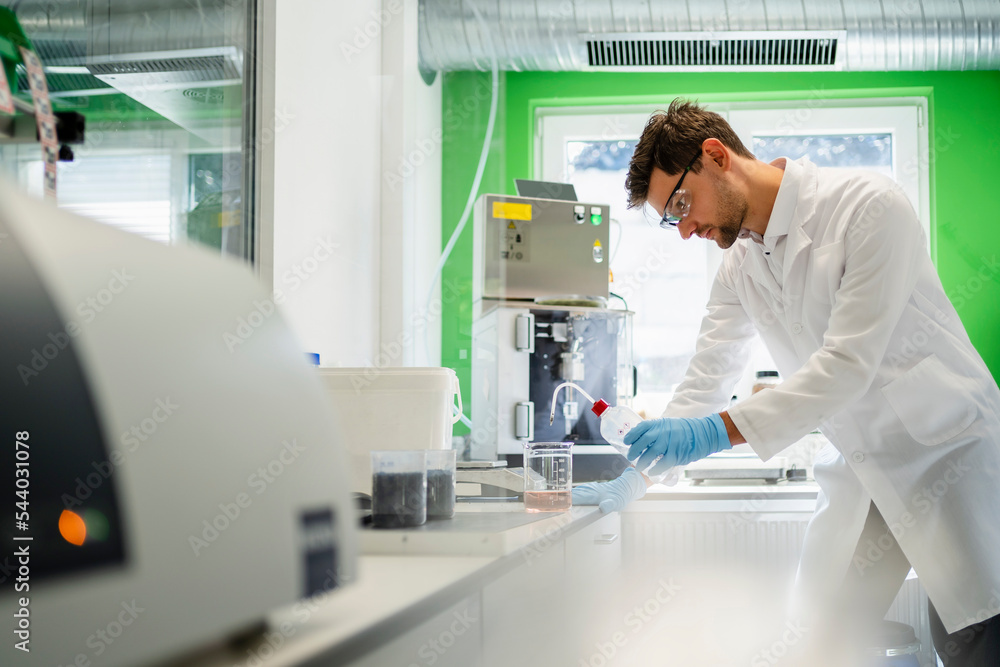Scientist doing thermolysis experiment in laboratory Scientist doing thermolysis experiment in laboratory