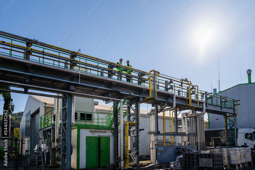 Engineers standing at recycling center on sunny day Engineers standing at recycling center on sunny day