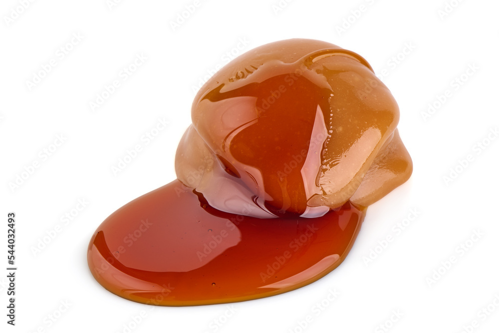 Caramel candies and caramel sauce, isolated on white background. Caramel candies and caramel sauce, isolated on white background.