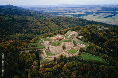 Fototapeta Naklejka Na Ścianę i Meble -  Srebrna Gora fortress and Sudety mountains at autumn season, aerial drone view. Military fort landmark for tourists in Lower Silesia, Poland