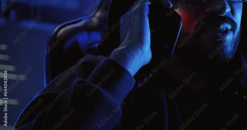 A male hacker is using a computer to hack data to demand ransom from victims.