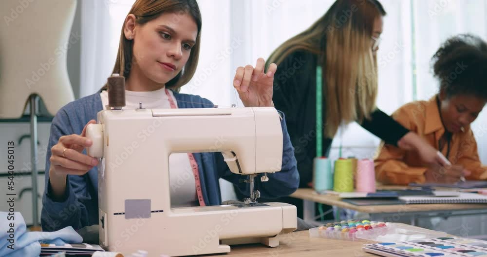 A group of young women are learning the profession of design and tailoring. A group of young women are learning the profession of design and tailoring.