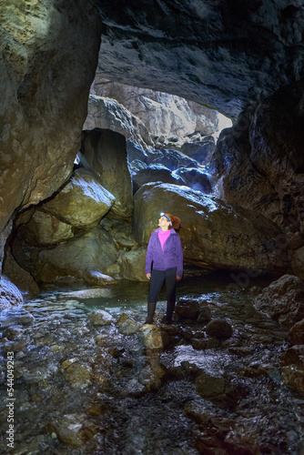 Woman hiking into a cave