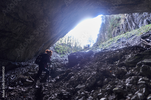 Woman hiking into a cave