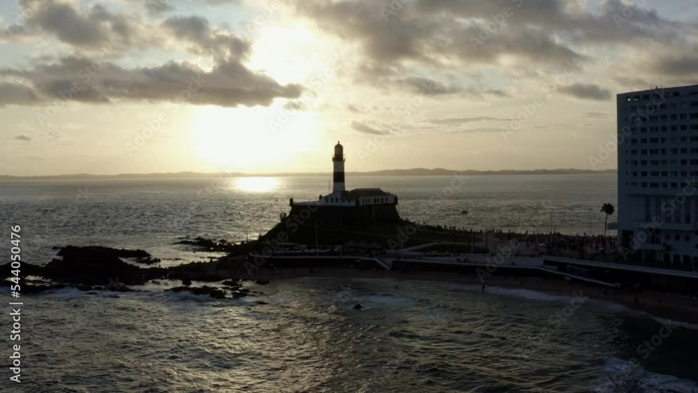 Dolly-in aerial drone shot approaching and passing the historical Barra or Santo Antônio Lighthouse in the cultural Afro-Brazilian city of Salvador in Bahia, Brazil towards the bay of all the saints. Dolly-in aerial drone shot approaching and passing the historical Barra or Santo Antônio Lighthouse in the cultural Afro-Brazilian city of Salvador in Bahia, Brazil towards the bay of all the saints.