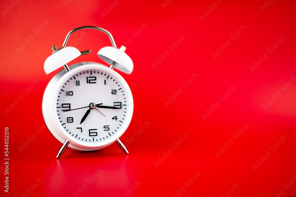 white alarm clock on red background time concept white alarm clock on red background time concept