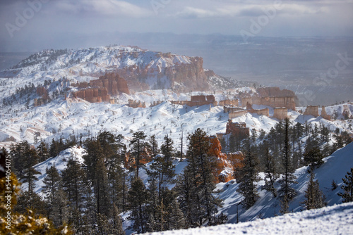 winter landscape of bryce canyon national park; freezing cold red rocks covered with snow, winter in the usa; landscape of mountains covered with snow, winter in the state of utah