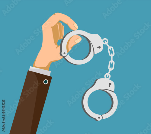 Hand of a policeman or detective is holding handcuffs