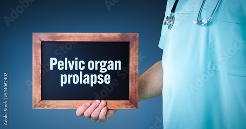 Pelvic organ prolapse. Doctor shows sign/board with wooden frame. Background blue photo