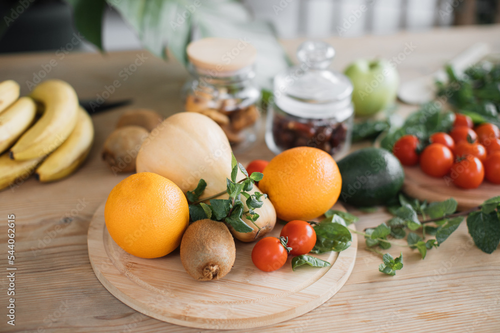 Fresh fruits and vegetables lying on wooden table, healthy lifestyle concept. Vegetarian foods background and banner of arrangement of fruits. Copy space. Fresh fruits and vegetables lying on wooden table, healthy lifestyle concept. Vegetarian foods background and banner of arrangement of fruits. Copy space.