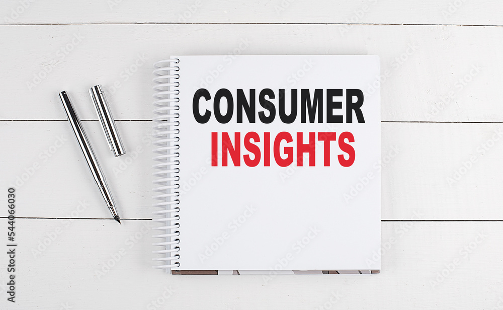 CONSUMER INSIGHTS text written on notebook on the wooden background CONSUMER INSIGHTS text written on notebook on the wooden background