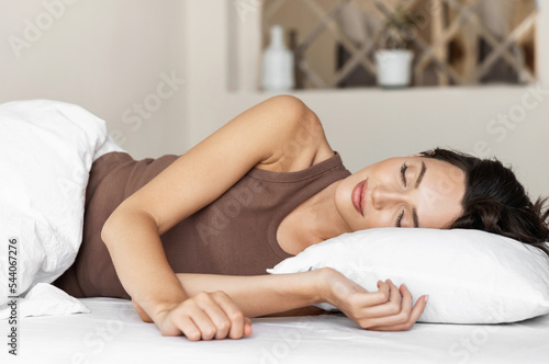 Young woman sleeping in bed, Cute woman in bedroom at home, Relaxation, resting, self care, healthy lifestyle, bedtime concept.