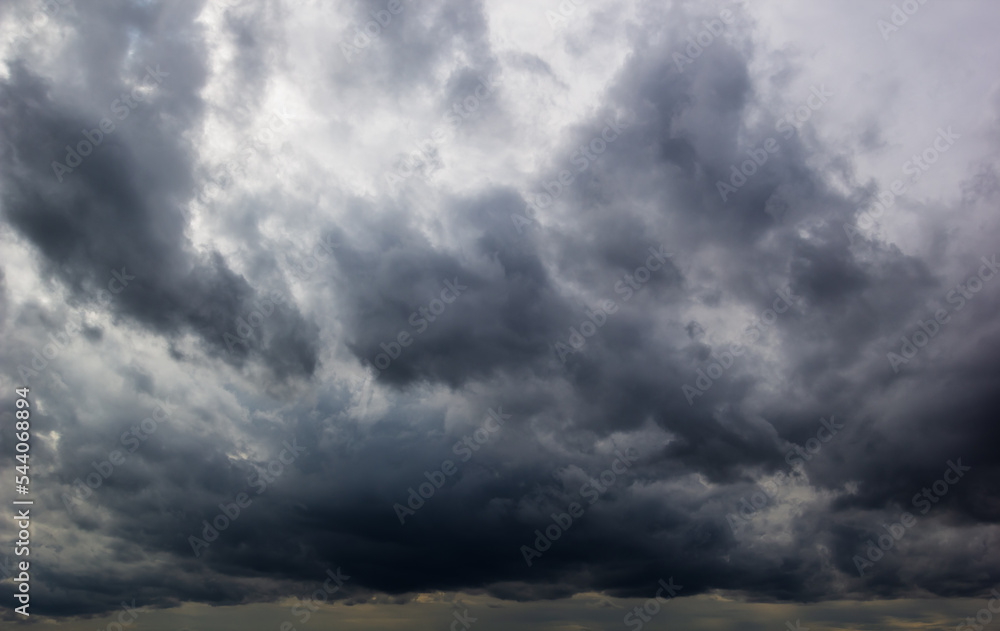 The dark sky with heavy clouds converging and a violent storm before the rain.Bad or moody weather sky and environment. carbon dioxide emissions, greenhouse effect, global warming, climate change The dark sky with heavy clouds converging and a violent storm before the rain.Bad or moody weather sky and environment. carbon dioxide emissions, greenhouse effect, global warming, climate change