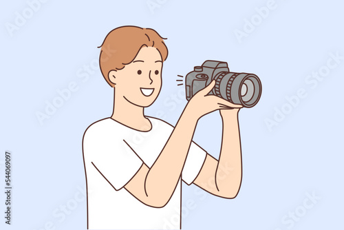 Smiling man with camera taking pictures 
