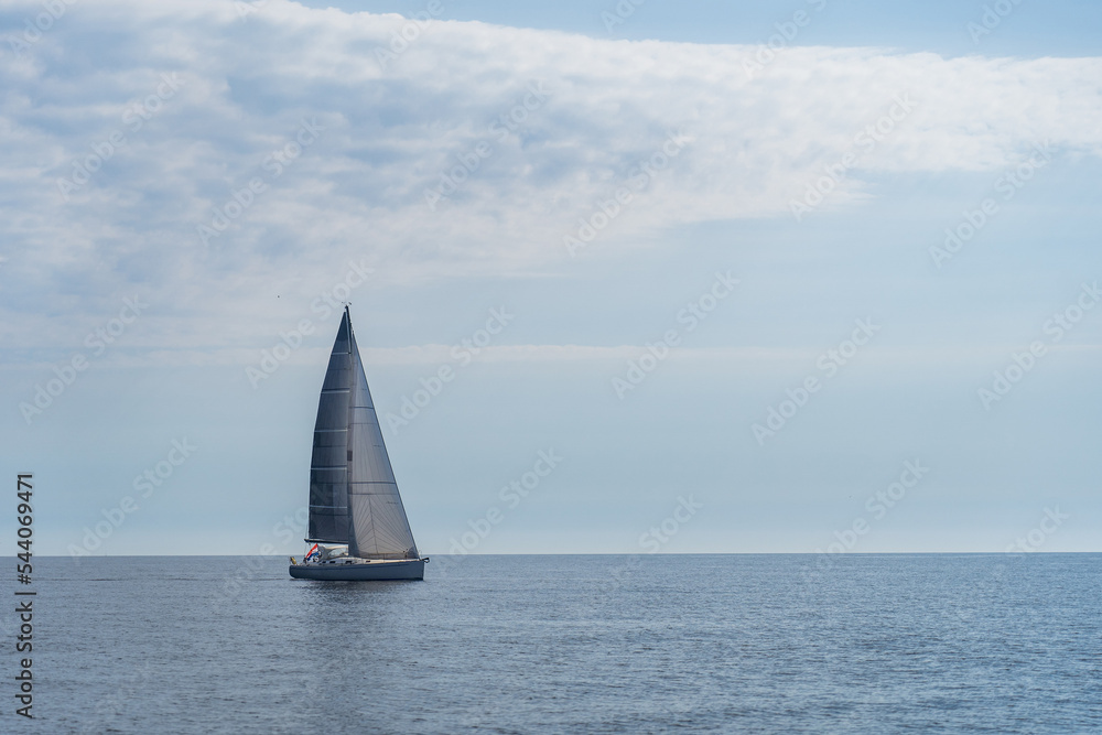 Sailing boat on blue open sea. concept of uncertain future, suspense and peradventure