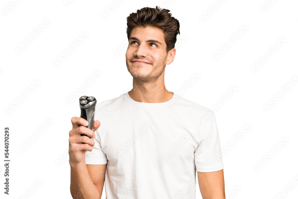 Young caucasian man holding a razor isolated dreaming of achieving goals and purposes Young caucasian man holding a razor isolated dreaming of achieving goals and purposes
